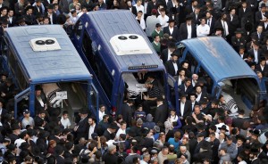 Image: The bodies of Kopinsky, Levine and Goldberg lie in vehicles during their funeral near the scene of an attack at a Jerusalem synagogue